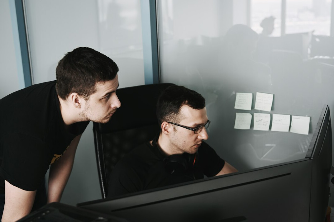 corporate team discussing code